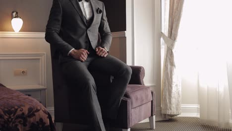 Handsome-groom-businessman-wearing-gray-jacket-at-home-in-living-room,-white-shirt-with-black-tie