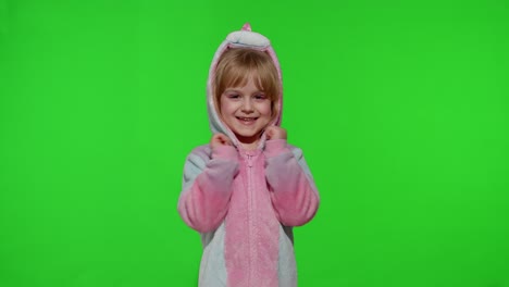 Little-blonde-child-girl-smiling,-dancing,-celebrating-in-unicorn-pajamas-costume-on-chroma-key