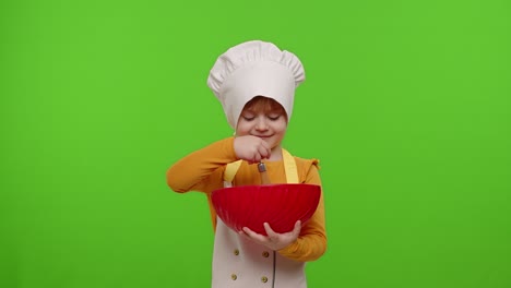 Child-girl-kid-dressed-as-cook-baker-chef-mix-dough-in-bowl,-prepare-cake-on-chroma-key-background