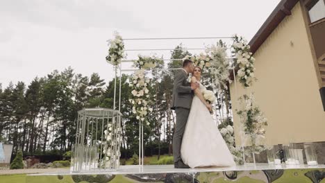 Newlyweds,-caucasian-groom-with-bride-walking,-embracing,-hugs-in-park,-wedding-couple