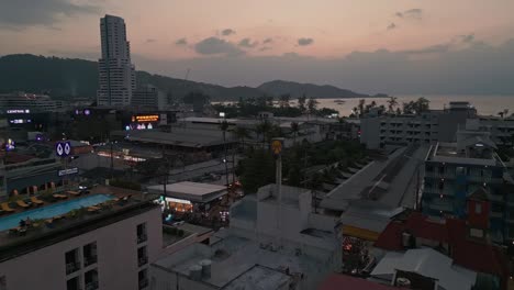 Aerial-view-capturing-Patong-Tower-situated-at-Patong-town-during-sunset-in-Phuket,-Thailand