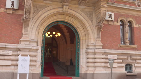 Tilt-down-view-of-entrance-of-vintage-Town-Hall-in-Dunkirk,-France-during-daytime