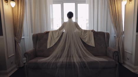 Bride-in-boudoir-dress-near-window,-wedding-morning-preparations,-woman-in-night-gown-and-veil