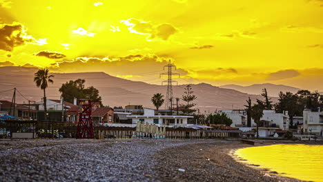 A-Picturesque-View-of-a-Coastal-Area-at-Sunset,-With-the-Water-Mirroring-the-Golden-Hues-of-the-Sky,-in-Greece---Timelapse