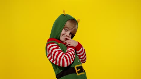 Kid-teen-girl-in-Christmas-elf-Santa-helper-costume-blows-air-kisses-at-camera,-hugging,-embracing