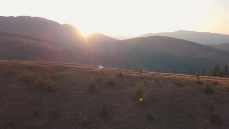 Newlyweds-walking-on-a-high-slope-of-the-mountain.-Groom-and-bride.-Aerial-view