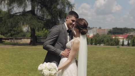 Lovely-newlyweds-caucasian-bride-groom-dancing-in-park,-making-kiss,-wedding-couple-family