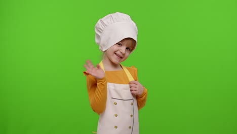 Child-girl-kid-dressed-as-cook-chef-waving-hands,-asking-to-follow-or-join,-welcome,-hello-gesture