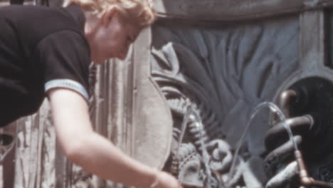 Woman-Drinks-Water-from-a-Public-Fountain-in-Washington-at-Daytme