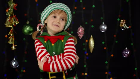 Displesed-kid-teenager-girl-in-elf-Santa-helper-costume-negative-emotions,-upset-on-Christmas-Eve