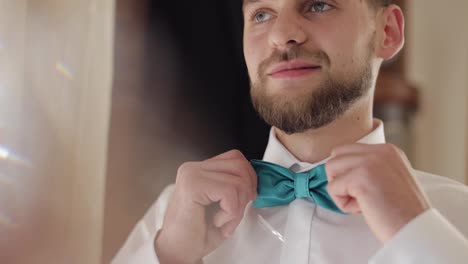 Groom-adjusts-bow-tie.-Preparing-to-go-to-the-bride.-Businessman.-Wedding-day