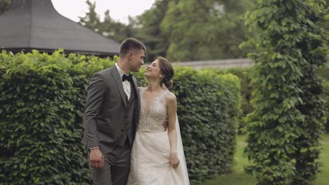 Lovely-newlyweds-caucasian-bride-groom-walking-in-park,-holding-hands,-wedding-couple-family