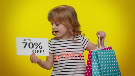 Kid-child-girl-showing-shopping-bags-and-Up-To-70-Percent-Off-inscriptions-banner-text,-Black-Friday