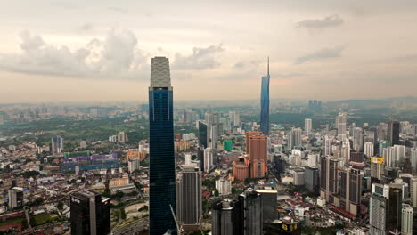 The-Exchange-106-and-Merdeka-118-skyscrapers-stand-out-in-KL-skyline,-aerial