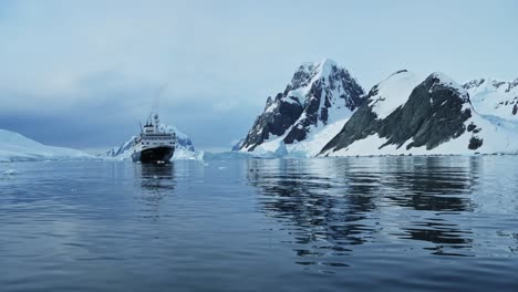 Antarctica-Ship-and-Mountains-Scenery,-Cruise-Ship-Boat-in-Beautiful-Dramatic-Amazing-Antarctic-Peninsula-Scenery-and-Winter-Landscape-on-Tourist-Travel-Vacation-and-Holiday-to-Antarctica