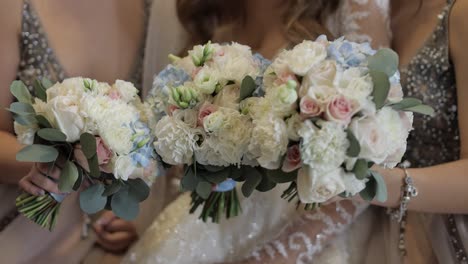 faceless-bride-and-two-bridesmaids-posing-with-bouquets.-Wedding