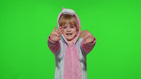 Little-child-girl-smiling,-waving-greeting,-hello-or-bye-with-hand-in-unicorn-pajamas-on-chroma-key