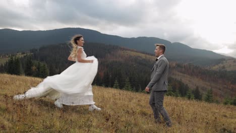 Lovely-newlyweds-bride-groom-dancing-on-mountain-autumn-slope-in-slow-motion,-wedding-couple-family