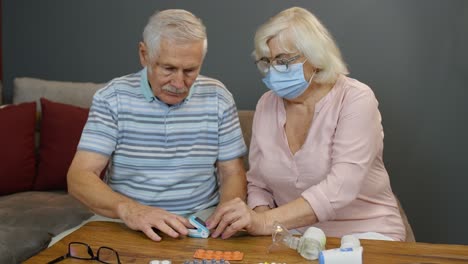 Senior-couple-grandfather-and-grandmother-monitoring-oxygen-saturation-with-digital-pulse-oximeter