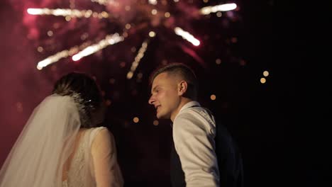 Couple-in-love-watching-fireworks.-Silhouette-newlyweds-on-fireworks-background