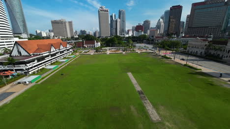 FPV-drone-shot-over-the-Dataran-Merdeka-square-in-sunny-Kuala-Lumpur,-Malaysia