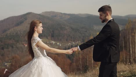 Newlyweds.-Caucasian-groom-with-bride-on-mountain-slope.-Wedding-couple.-Happy