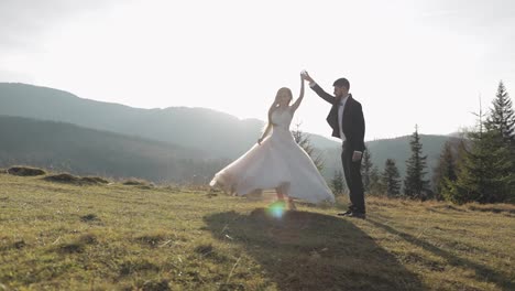 Newlyweds.-Caucasian-groom-with-bride-dancing-on-mountain-slope.-Wedding-couple