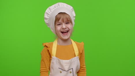 Charming-child-girl-dressed-like-chef-cook-laughing-out-loud-after-hearing-ridiculous-anecdote