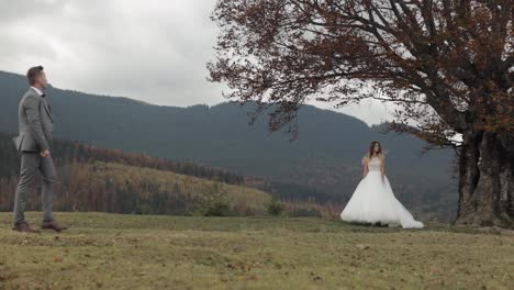 Lovely-caucasian-wedding-couple-newlyweds-family-bride-groom-stay-together-on-mountain-slope-hill