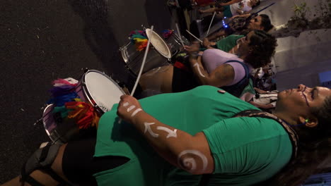 vertical-shot-of-drum-performers-in-peaceful-abortion-march-at-night-with-white-body-paint