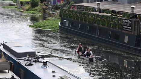 Three-ladies-rowing-along-the-River-Lee,-London,-United-Kingdom