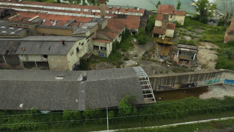 Abandoned-ceramic-factory-with-overgrown-plants-and-graffiti-covered-walls-in-Italy