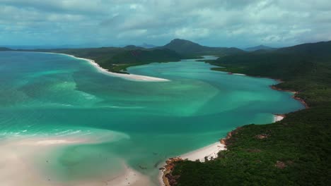 Hill-Inlet-Lookout-aerial-drone-view-Whitsundays-Island-North-end-Whitehaven-beach-QLD-Australia-Port-of-Airlie-National-Park-clear-turquoise-ocean-water-blue-sky-cloudy-boats-tourists-backwards-pan