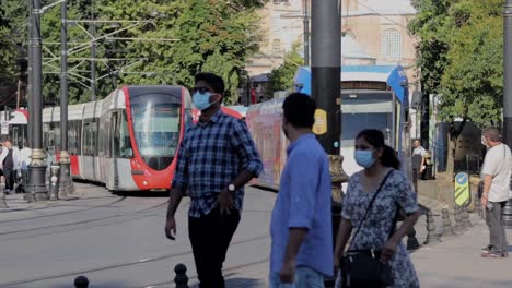 A-tram-passes-through-a-bustling-pedestrian-area-in-Istanbul,-Turkey