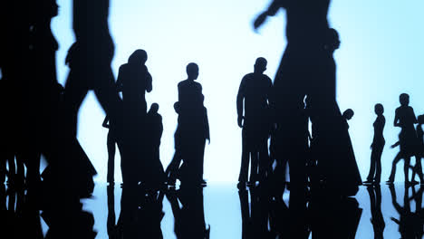 Aerial-view-of-the-silhouettes-of-a-crowd-of-people-on-the-bright-background.-Group-of-people-standing-idle-or-waiting-isolated-on-blue-background.-Corporate-business-standing-gathered-silhouettes.