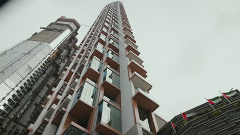 Underview-from-the-street-of-the-SLS-Building-Residences-and-Hotel-in-Business-Bay,-Dubai,-highlighting-its-luxurious-balconies-and-modern-architecture-against-the-cityscape