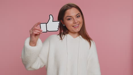 Young-woman-girl-raises-thumbs-up-agrees-or-gives-positive-reply-recommends-advertisement-likes-good