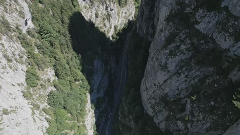 slow-aerial-descent-into-the-Bicaz-Chei-gorge-with-roadway-below-in-Romania