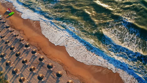 Aerial-drone-shot-of-a-tropical-beach-at-sunset