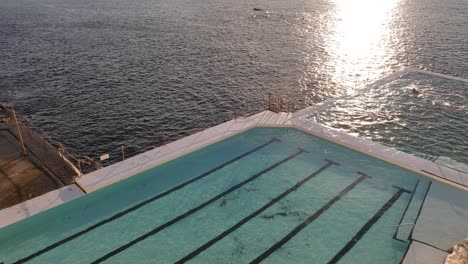 Elevated-close-view-of-the-Bondi-Icebergs-pool-at-sunrise,-Bondi-Beach