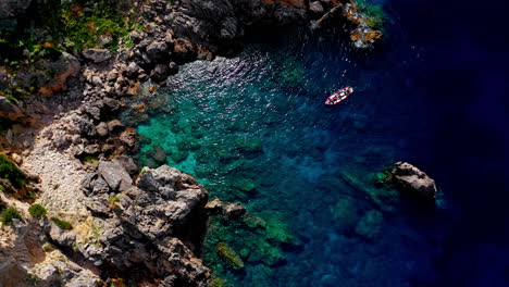 Top-down-aerial-drone-view-of-the-picturesque-rocky-coastline-of-Paleokastritsa-in-Corfu,-Greece