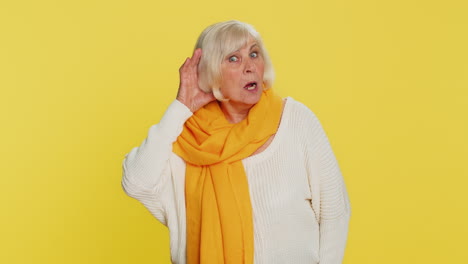 Senior-old-woman-trying-hear-you-looking-confused-and-frowning-keeping-arm-near-ear-for-louder-voice