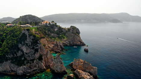 Aerial-drone-shot-over-the-picturesque-rocky-coastline-of-Paleokastritsa-bay-in-Corfu,-Greece