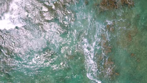 Drone-top-view-of-waves-crashing-at-Cromwells-beach-in-Kahala,-Oahu,-Hawaii