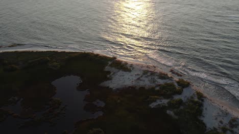 Plataforma-Aérea-Inclinada-Hacia-Arriba-Para-Ver-La-Puesta-De-Sol-Sobre-Las-Marismas-De-La-Isla-Barrera-En-Chincoteague,-Virginia