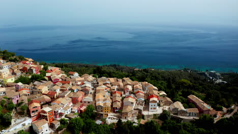 Aerial-drone-shot-over-old-Greek-mountain-village-of-Lakones-in-Corfu-surrounded-in-green-lush-vegetation