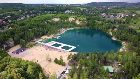 Natural-swimming-pool-and-recreation-area-surrounded-by-greenery-in-Balaton,-Poland