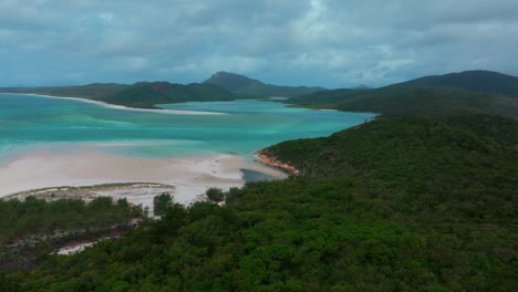 Hill-Inlet-Lookout-parallax-aerial-drone-view-Whitsundays-Island-North-end-Whitehaven-beach-QLD-Australia-Port-of-Airlie-National-Park-stunning-clear-turquoise-ocean-water-sunny-cloudy-motion-right