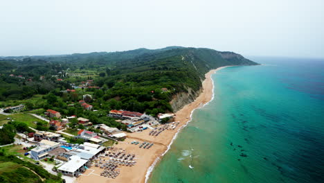 Aerial-drone-shot-over-the-long-stretching-empty-sandy-beach-in-Corfu-in-Greece