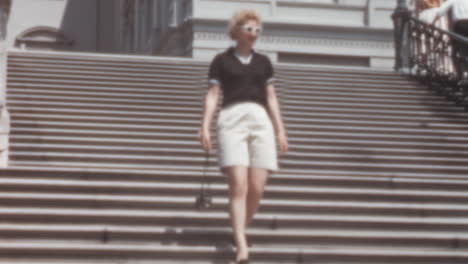 Woman-in-Classic-50s-Fashions-Descends-Stairs-in-Front-of-U